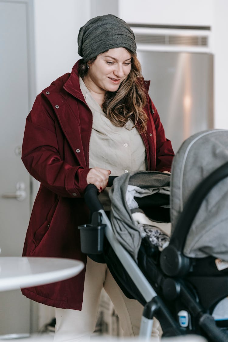 Happy Mother With Baby In Stroller