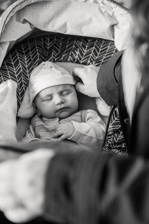 Free Cute baby sleeping in stroller Stock Photo