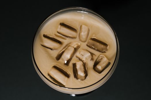 Refreshing iced coffee with visible ice cubes from above, showcasing chilled beverage.