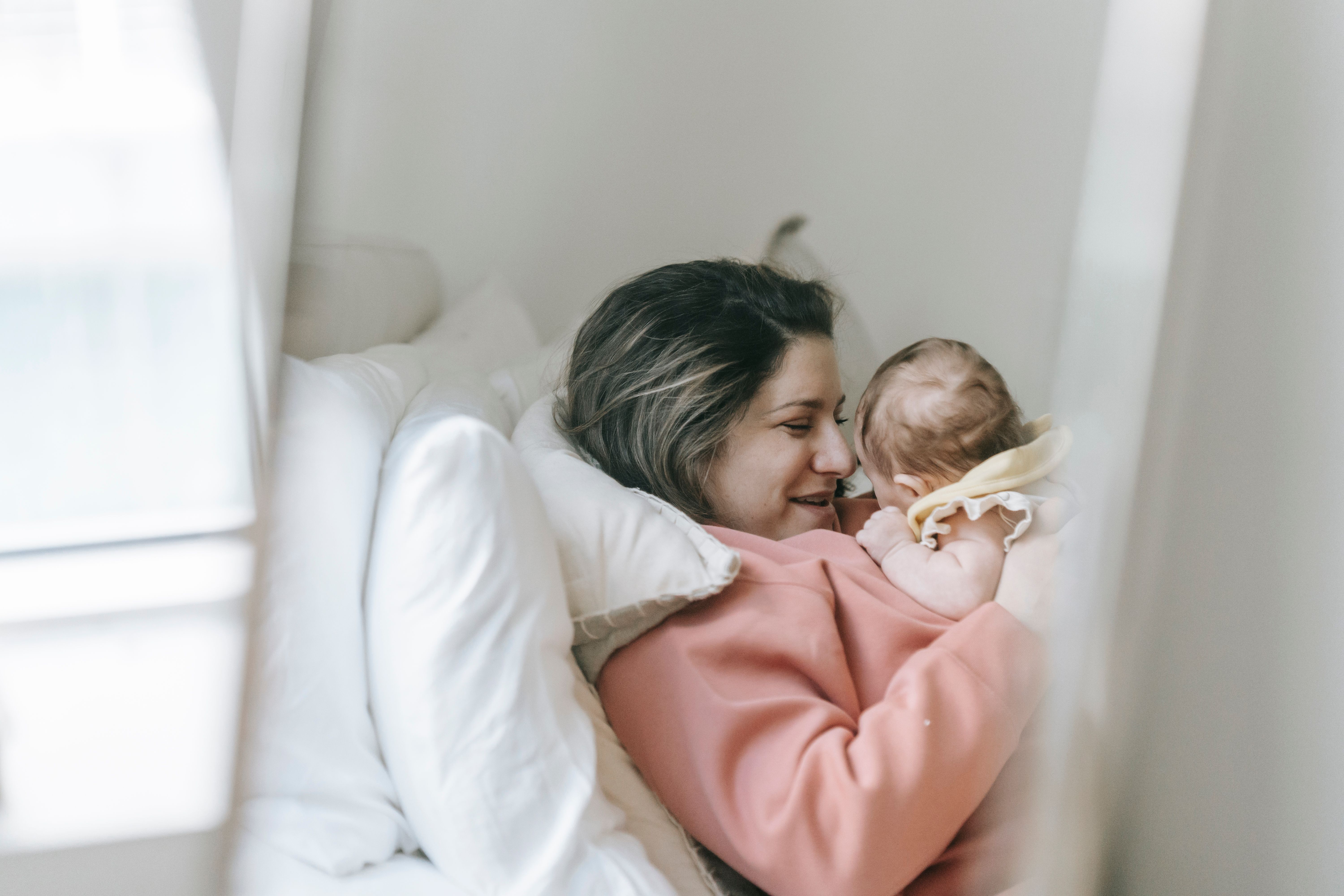 Close-up of parent gently holding a newborn baby's feet, symbolizing love and care.