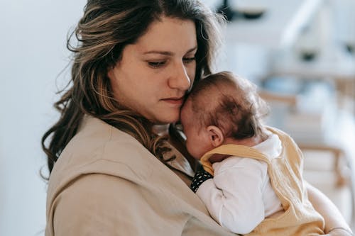 Free Mother Carrying Her Baby Stock Photo