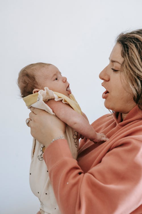 Free Close-Up Shot of a Mother Holding Her Baby Stock Photo