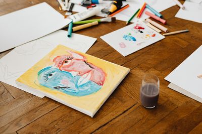 Watercolour studies drying on a workbench — photo by Kaboompics on Pexels