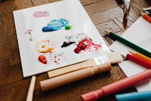 Free Photo of Paint Near Colored Pencils Stock Photo