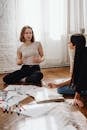 Two Women Having a Conversation while Sitting on the Floor