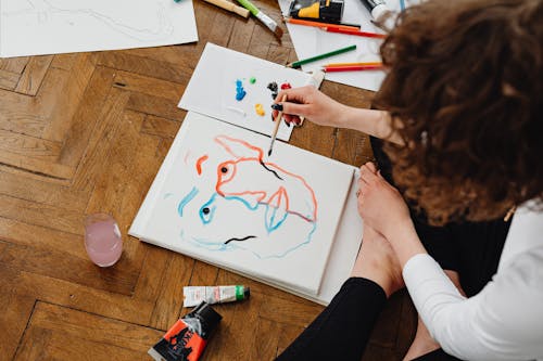 Free Person Painting while Sitting on the Floor Stock Photo