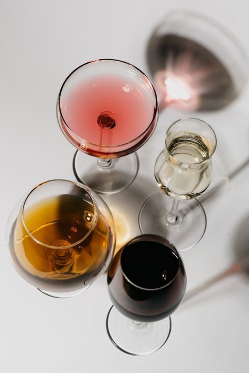 Free A top view showcasing a variety of wines in glasses on a white background, perfect for beverage themes. Stock Photo