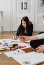 Woman in Black Blazer Sitting at the Table