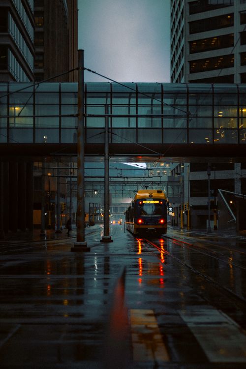 Free A moody evening street scene in downtown Minneapolis featuring a public bus beneath city lights. Stock Photo
