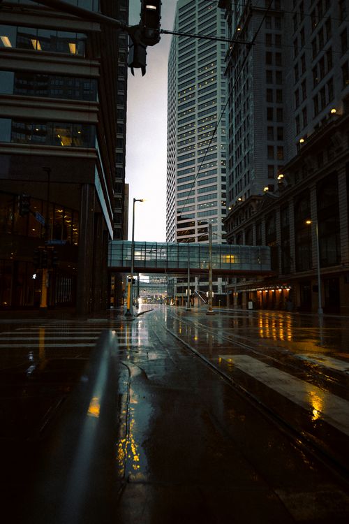 Free A beautiful cityscape of Minneapolis captured during a rainy day featuring a skybridge and wet streets. Stock Photo