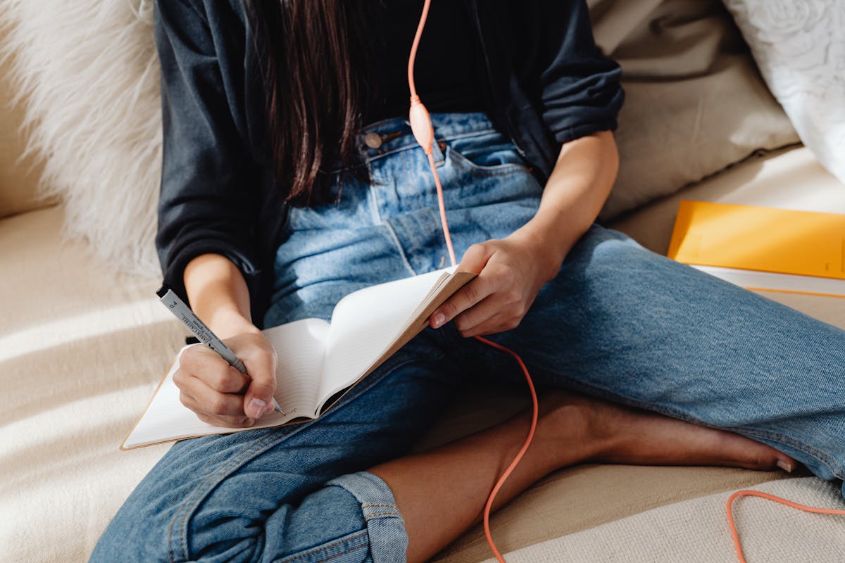 Person journaling and reflecting on emotional growth in recovery