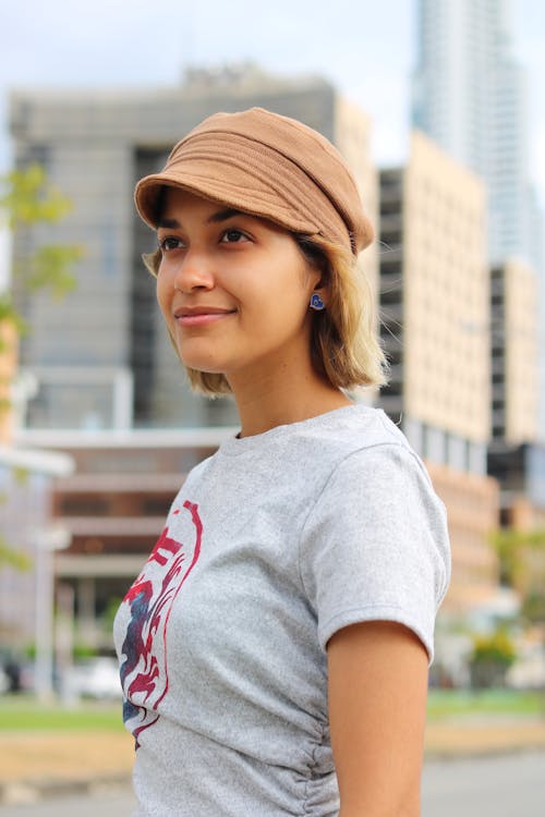 Woman in Gray Crew Neck T-shirt Wearing Brown Hat