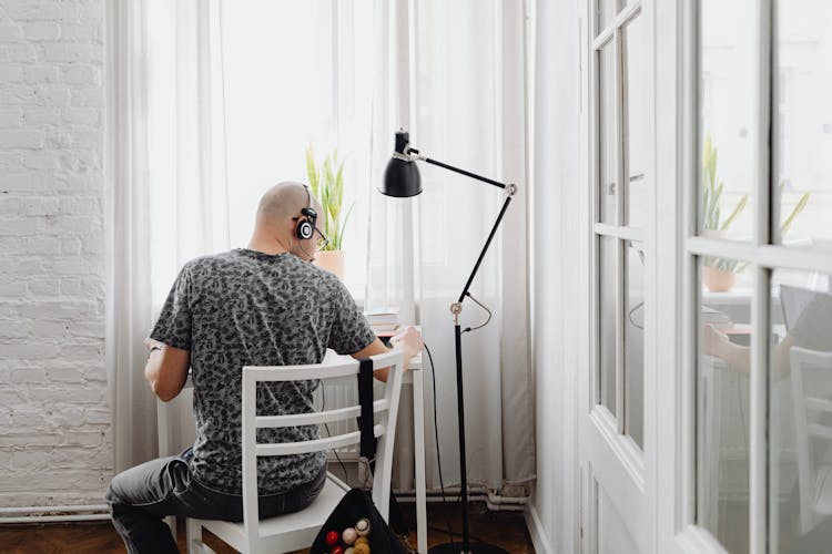 Back View Of A Man Sitting On The Chair