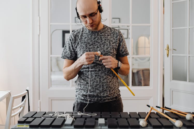 Musician Man Standing Before Xylophone And Improving Sticks