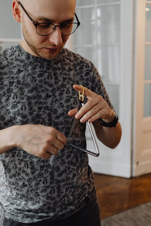 Man Playing Triangle Instrument