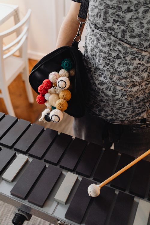 Free Musician holding colorful mallets over xylophone keys, ready to play. Stock Photo