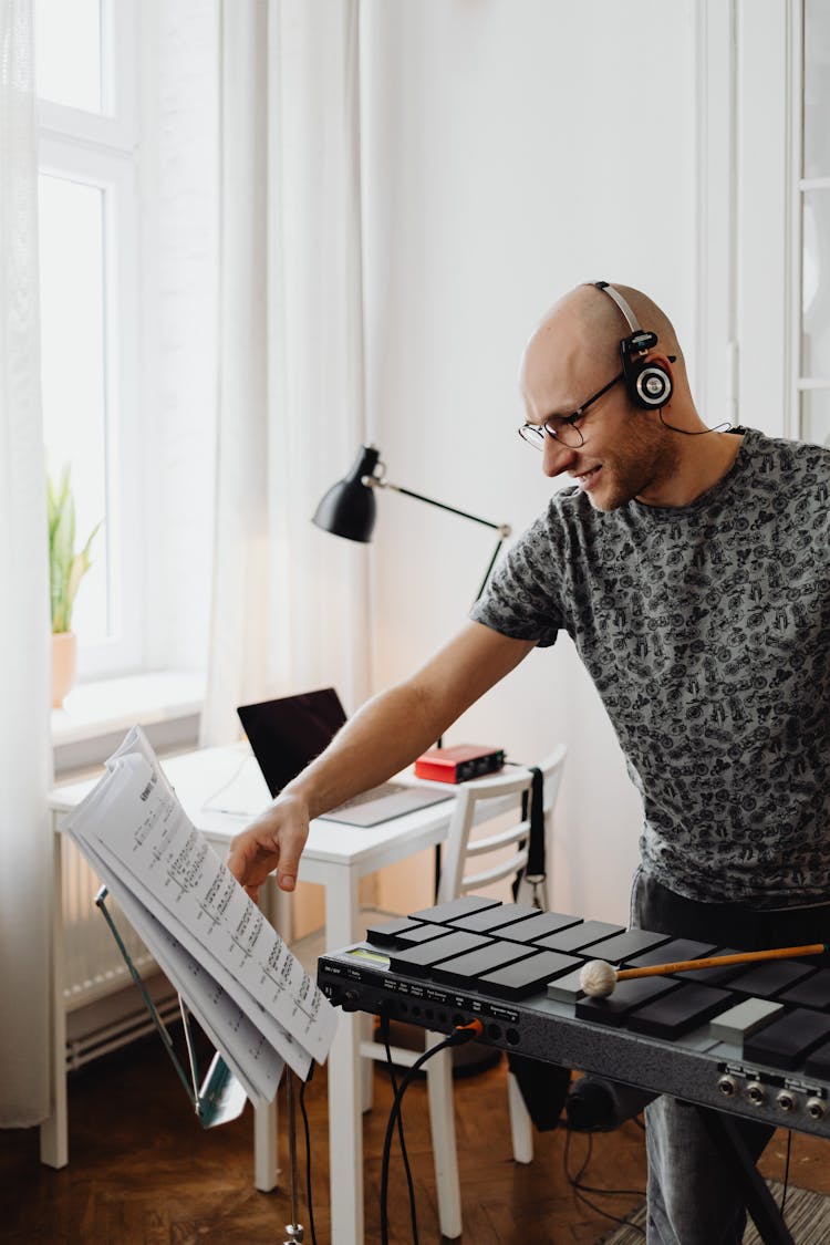 Bald Man Flipping The Pages Of Music Book 