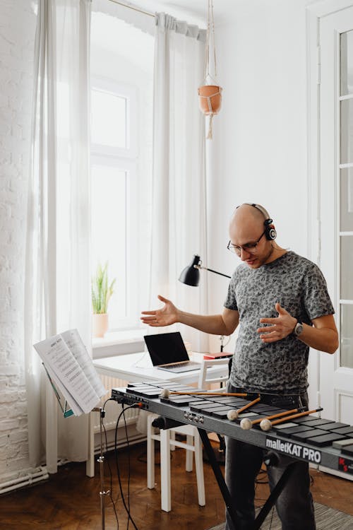 Free Man Standing Looking at His Xylophone Stock Photo