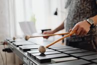 Man Playing a Black Xylophone