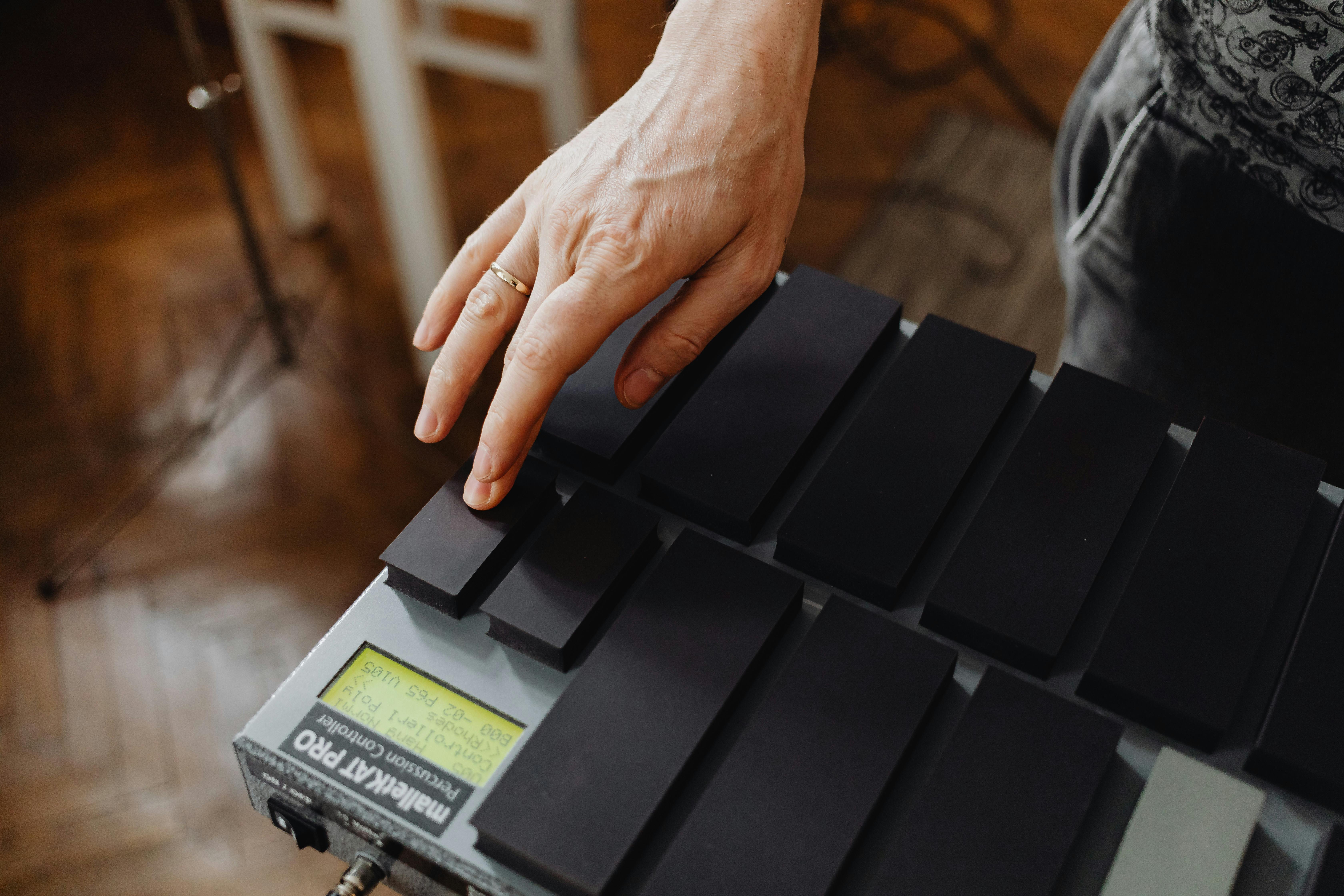 Close-up View of Hand on Key of Instrument · Free Stock Photo