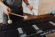 A Person Holding Mallets