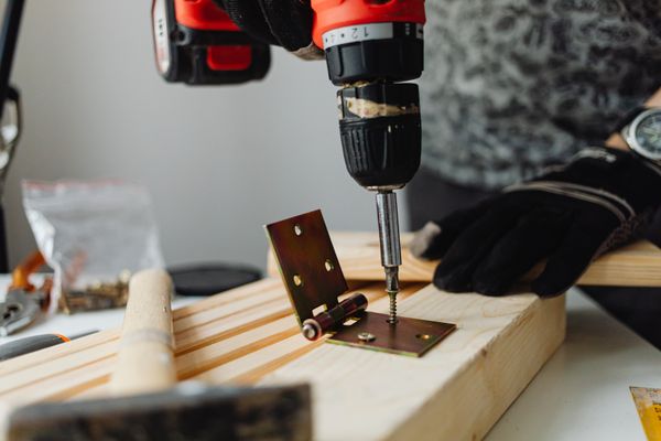 Carpenter using a power drill on a home fitting