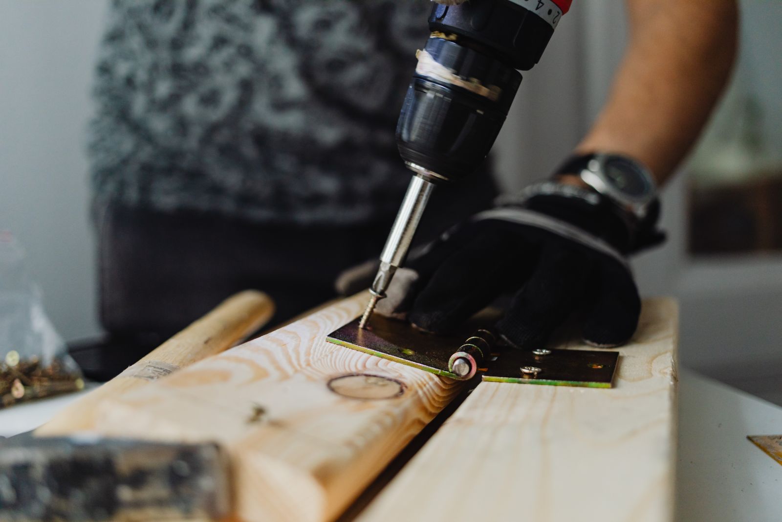 Handyman using a drill for a detailed home repair project serving Ridgefield Washington homeowners
