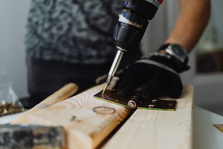 Handyman drilling a screw into wood