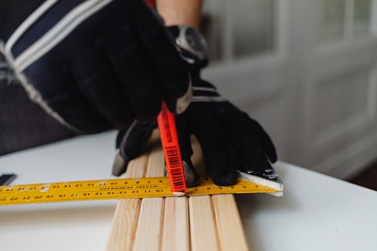 Carpenter Drawing Cutting Line On Wooden Board