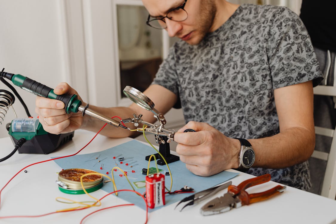  A man using a soldering iron 