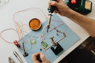 A Person Using a Soldering Iron