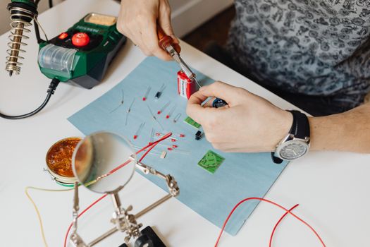 Person holding a Plier and a Cable String 