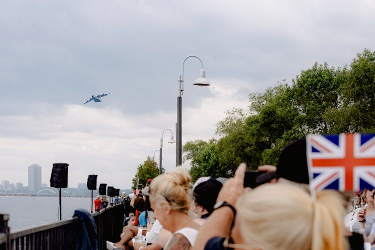 Unrecognizable Citizens Contemplating Air Show From Embankment On Aviation Day