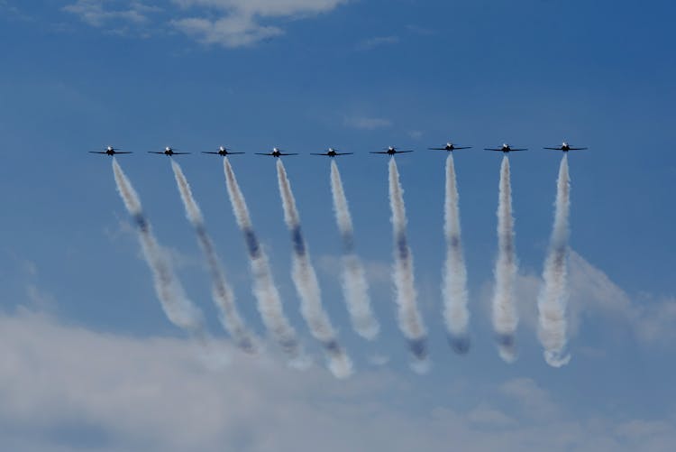 Air Show With Airplanes Creating Traces In Blue Sky