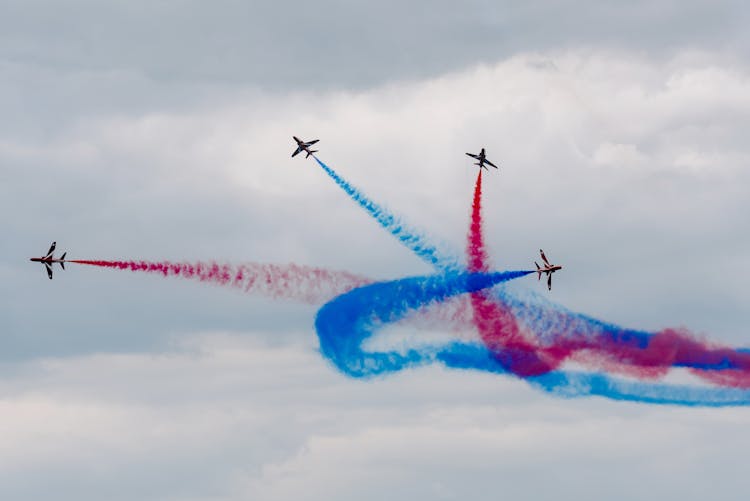 Air Show With Planes Creating Curved Traces In Cloudy Sky