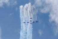 Aircrafts creating air tattoo in cloudy sky
