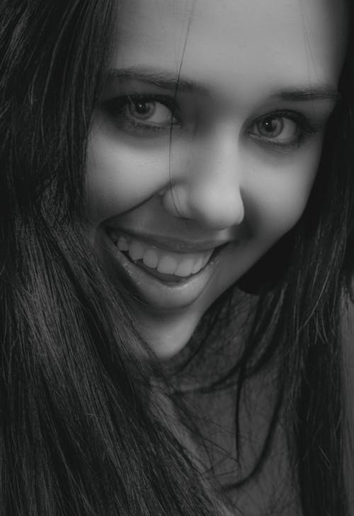 Smiling Woman in Grayscale Photo