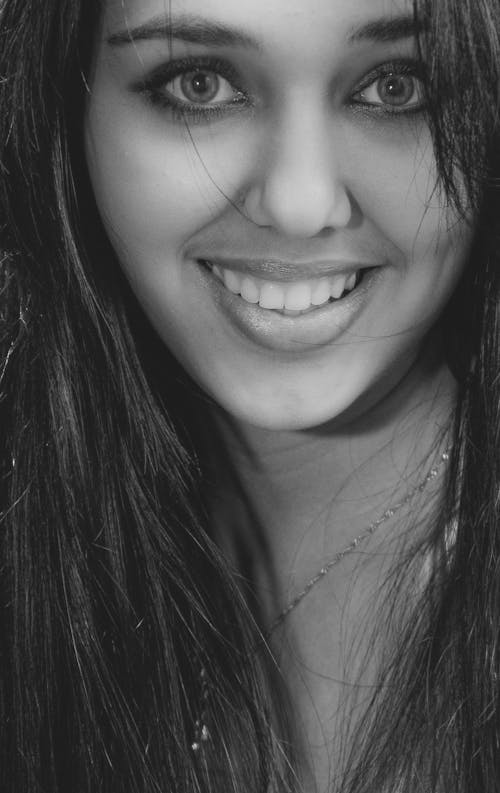 Smiling Woman Wearing in Grayscale Photo