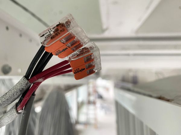 Splicing electrical connectors with stripped wire ends shown in close-up detail