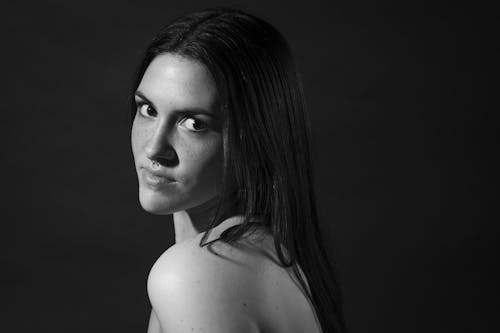 Grayscale Photo of a Topless Woman With Black Hair