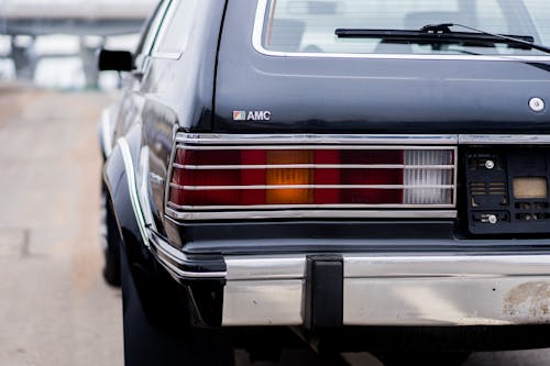 Taillights of aged automobile on road