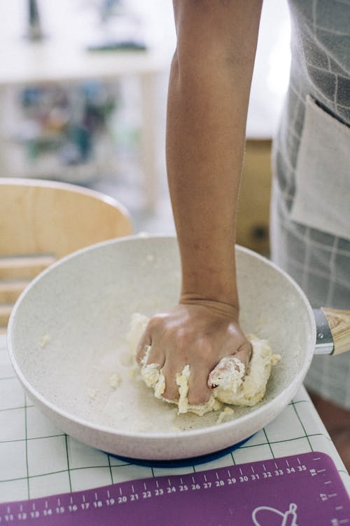 A Person Mashing a Dough