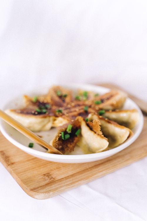 Free A plate of delicious crispy dumplings garnished with green onions. Stock Photo