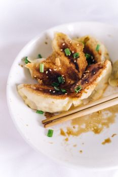 Delicious crispy dumplings with chives and sesame seeds, perfect for food enthusiasts.