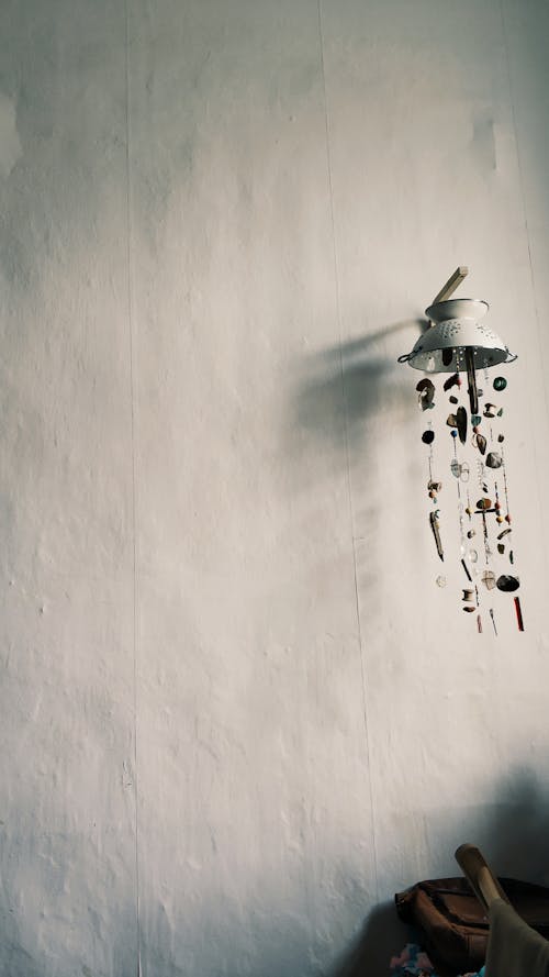 Free Handmade wind chimes hanging on light wall Stock Photo