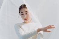 A Woman in White Lace Long Sleeve Dress