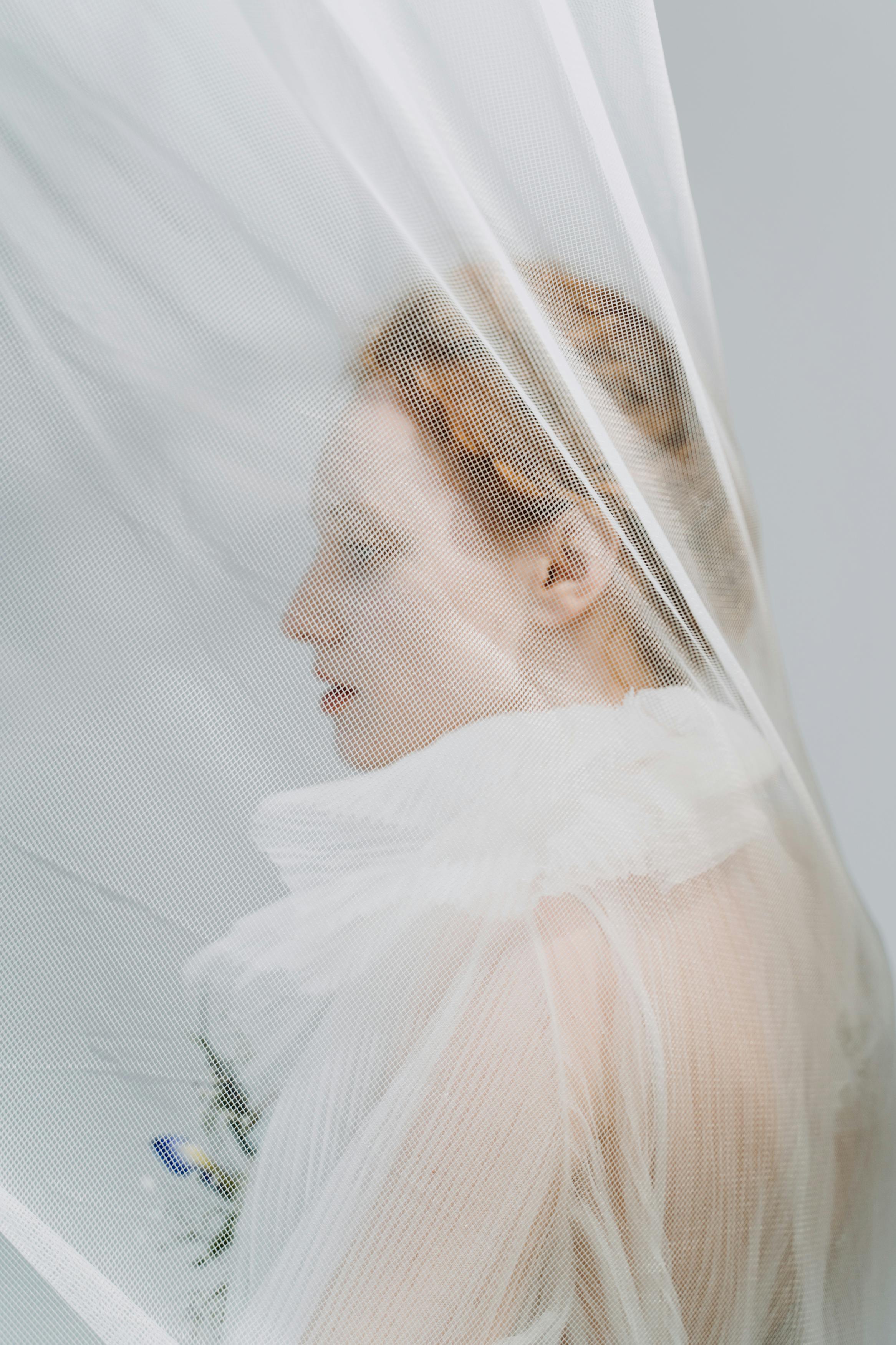 redhead woman wrapped in white tulle