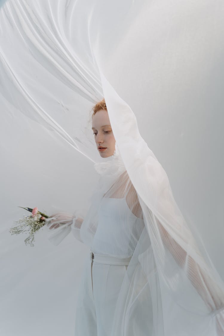 Wedding Fashion Model In White Clothing Covered With Tulle Fabric