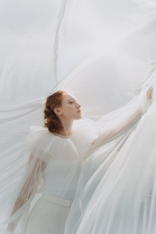 Woman Holding a White Fabric