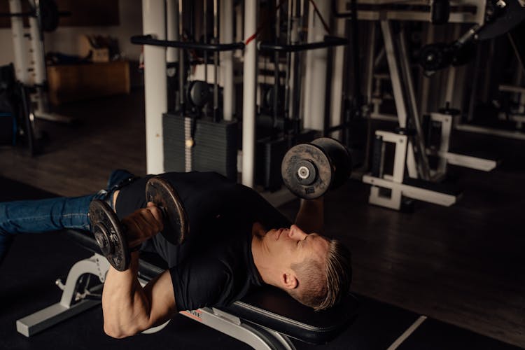 A Man Doing A Dumbbell Chest Press